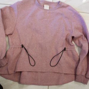 Varley dressy sweattop in Heather Pink with drawstrings on the side waist
